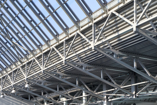 Modern architectural ceiling design with steel beams and glass panels in contemporary building interior - Powered by Adobe