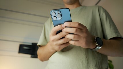 a man is holding a blue smartphone