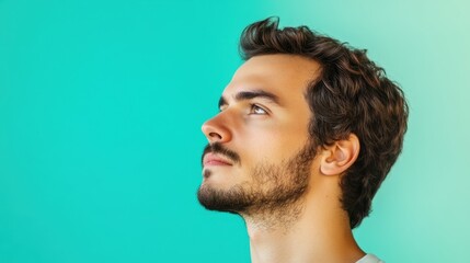 Fototapeta premium Thoughtful Man in Profile Against a Gradient Background