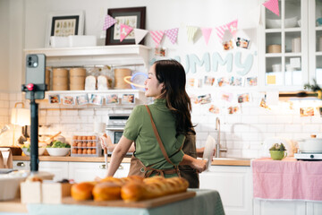 Kitchen Live Streaming, Asian Woman Cooks Fresh Vegetables and Prepares Delicious Meals Using Technology, Sharing Recipes and Culinary Tips on Her Blog with Smartphone, Embracing a Vibrant Lifestyle
