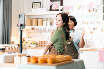 Kitchen Live Streaming, Asian Woman Cooks Fresh Vegetables and Prepares Delicious Meals Using Technology, Sharing Recipes and Culinary Tips on Her Blog with Smartphone, Embracing a Vibrant Lifestyle