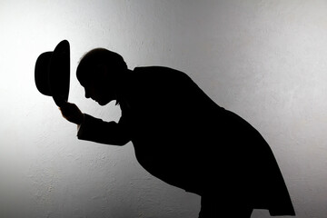 Silhouette of Polite British Butler Bowing and Doffing Bowler Hat. Service Industry and...