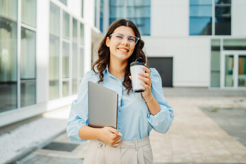 Fototapeta premium Young successful woman is going to work at modern business building