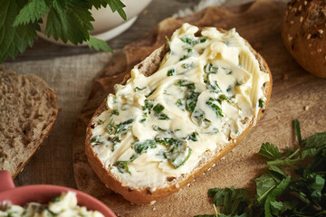 A bun with nettle butter - homemade bread spread made of wild edible plants