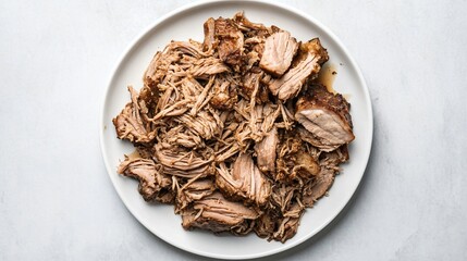 Slow-roasted pork shoulder, shredded, arranged on a simple white plate