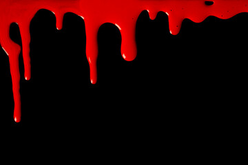 Red paint drips on a black background.