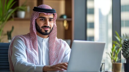Portrait of a Confident Arab Businessman Using a Laptop
