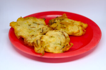 fried bakwan food served on a red plate