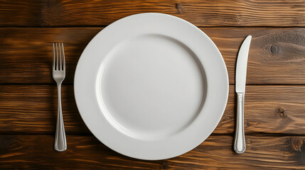 Top-Down View of a White Plate on a Wooden Table