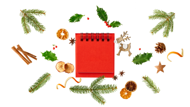 Blank red desk calendar with Christmas decor. Fir branches, holly berry, pine cone, dried apple and orange slices, cinnamon sticks, anis stars isolated on white