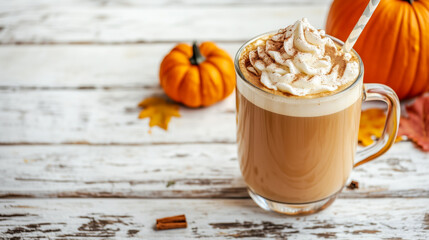 Close-up of glass mug of pumpkin spice latte with whipped cream and cinnamon on rustic wooden table. Concept of cozy autumn beverages and seasonal comfort.