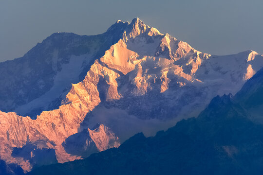 Beautiful first light from sunrise on Mount Kanchenjugha, Himalayan mountain range, Sikkim, India. Orange tint on the mountains at dawn