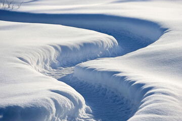 A mesmerizing snow-covered landscape featuring curving paths, capturing the serene and tranquil beauty of winter with its pristine white snow and natural formations.