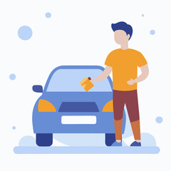 A man is standing next to a car and holding a cloth. The car is blue and has a license plate