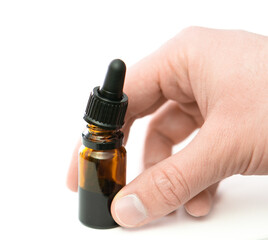 hand holding essential oil glass transparent bottle with a pipette dropper isolated on white background