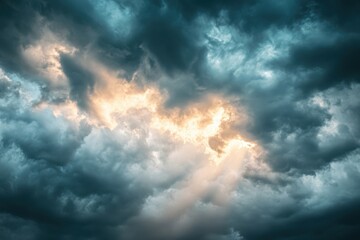 Fototapeta premium Enigmatic gloomy skies teeming with threatening clouds prior to rainfall as creative canvas, intense climate, rays of sun piercing the shadows, striking contrast visuals