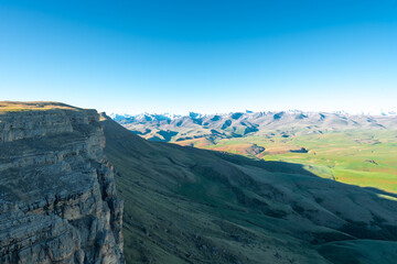 A picturesque view of a rocky cliff against the background of the North Caucasian ridge in the Elbrus region