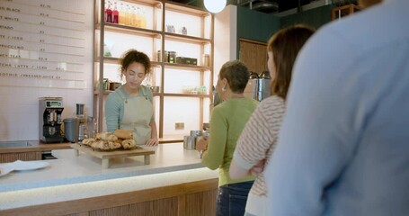 African American Barista Serving Customers at a Cafe Counter - Powered by Adobe