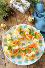 Creative appetizers christmas. Shrimp on pineapple with cheese filling on a rustic table.