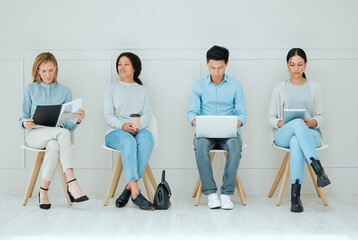 Group, business people and waiting room for hiring, interview or job opportunity. Line, chair and recruitment candidates prepare for career search on tech, reading resume and employee cv at hr office