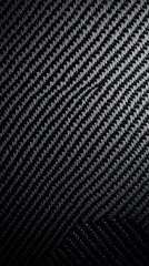 A close-up view of a textured black carbon fiber surface, highlighting its unique pattern and sleek design.