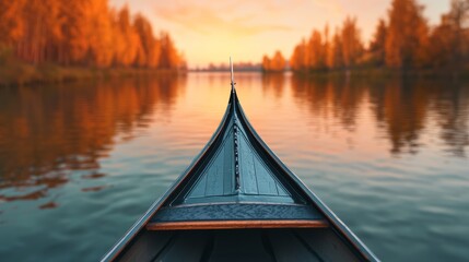 Obraz premium Serene view from a canoe on a calm lake with autumn trees reflecting in the water during sunset.