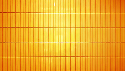 close up image of bright yellow ceramic clay wall tiles use as background with blank space for design. abstract interior wall finishing material. tiles background. subway brick in vertical pattern.