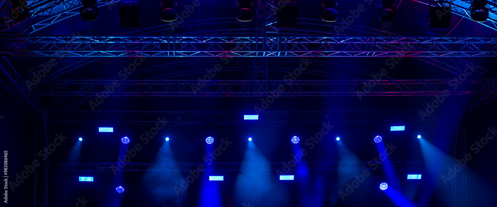 Wall mural light beams in blue tones on a live music concert scene