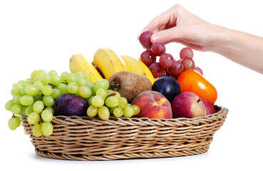 fresh fruits in a square basket in female hands on white background isolation