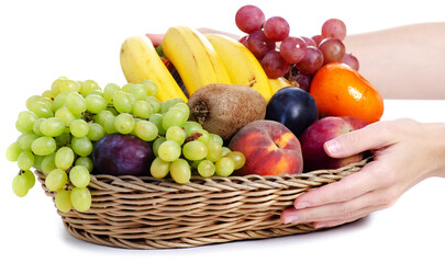 fresh fruits in a square basket in female hands on white background isolation
