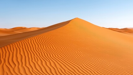 A stunning view of a solitary desert dune with rippled sand under a clear blue sky, showcasing the beauty of nature.