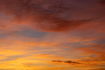 The stunning evening sky is filled with colorful clouds illuminated by the setting sun, creating a breathtaking view of nature's beauty