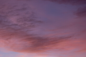 Calming sunset with pink and purple clouds blending in a beautiful sky. Vibrant colors create a serene atmosphere perfect for backgrounds