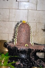 A Shiva Lingam adorned with flowers, symbolizing worship and spirituality.