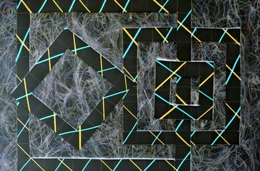 Abstract geometric design featuring colorful lines and shapes on a textured background.