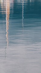 Abstract sea background - calm sea surface with marina reflection
