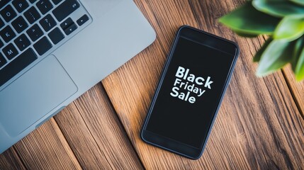 Laptop and smartphone display 'Black Friday Sale' ads on a desk with office supplies. Ideal for business promotions.