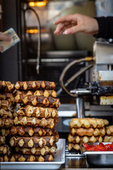 A waffle stall in the Belgian city of Ghent, with money being exchanged for a purchase in the background