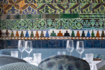 Restaurant in Triana district, Sevilla, served for lunch or dinner empty tables with walls covered with traditional Sevillian ceramic tiles