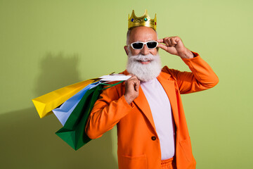 Photo of handsome pensioner mister king shopping bags luxury wear stylish orange classy garment...