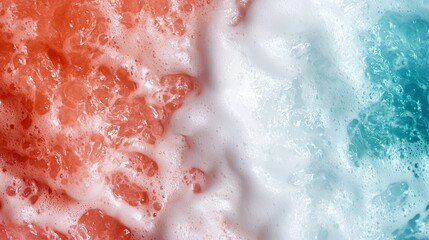 Fototapeta premium A tight shot of a frothy surface featuring a red-blue blend at its center, encircled by white substance within the foam