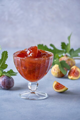 Fig jam in a glass jar and bowl. Fruits preserve