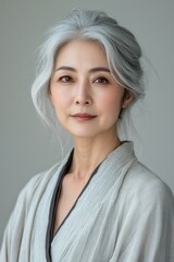 Creative Elegant Mature Woman with Silver Hair in Traditional Attire Posing Confidently.