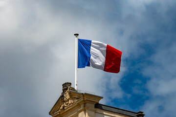 Blue red white french flag on roof of ciry hall in France