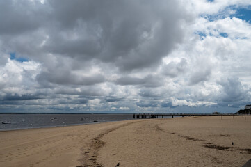 Walking on beach promenade in Arcachon, vacation destination town on Atlantic coast with beatiful...