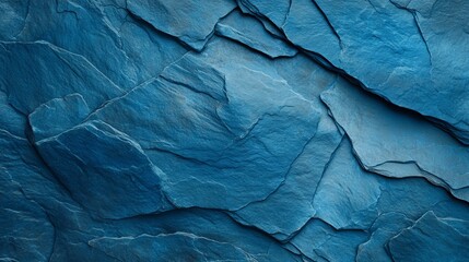 Fototapeta premium Close-up of textured rock wall with blue patterned surface, featuring a distinct central crack