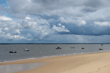 Walking on beach promenade in Arcachon, vacation destination town on Atlantic coast with beatiful parks, villas, streets and sandy beach, France