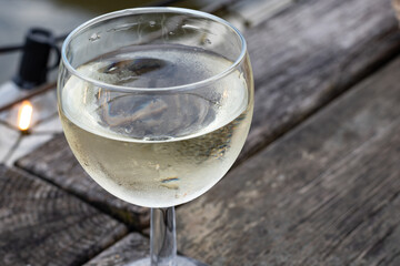 Tasting of Bordeaux white wine, right bank of Gironde Estuary, France. Glasses of white sweet French wine served in outdoor restaurant