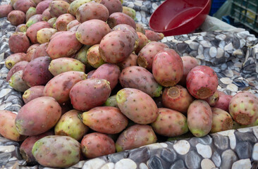 Ripe juicy edible fruits opuntia prickly pears cacti for sale on Triana farmer market in Sevilla, Andalusia, Spain