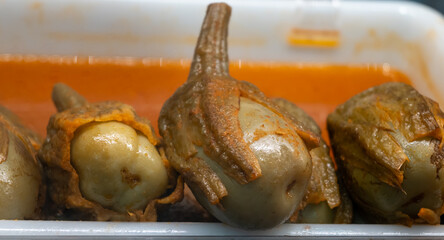 Pickled and marinated mini eggplants vegetables on farmers market, variety of tasty tapas in...